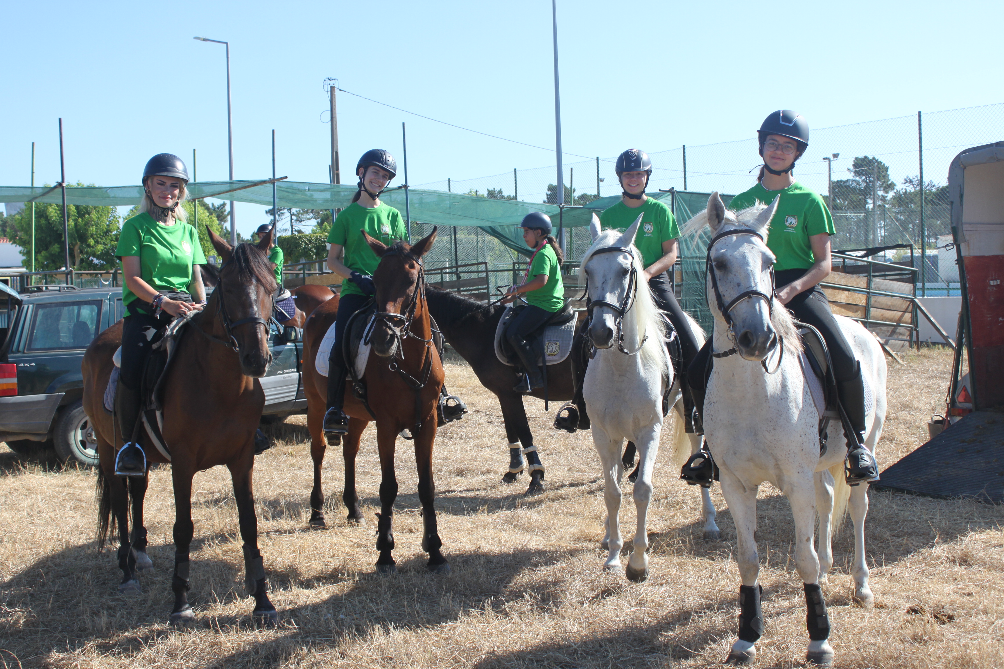 A person tacking up a horse in a stable